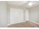 Bedroom features carpet, neutral walls, bi-fold closet doors and a ceiling fan at 2329 W Keating Ave, Mesa, AZ 85202