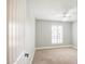 Bright bedroom featuring neutral carpeting, white trim, and a window with plantation shutters at 2329 W Keating Ave, Mesa, AZ 85202