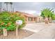 Charming home exterior with blooming foliage and desert landscaping, offering curb appeal and a welcoming entrance at 2329 W Keating Ave, Mesa, AZ 85202