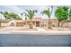 Charming single-story home with desert landscaping and a red tile roof, complemented by mature palm trees at 2329 W Keating Ave, Mesa, AZ 85202