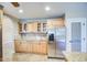 Beautiful kitchen featuring custom wood cabinets, granite countertops, and stainless steel refrigerator at 2329 W Keating Ave, Mesa, AZ 85202