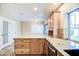 Spacious kitchen island featuring granite countertops, custom wood cabinets and backyard views at 2329 W Keating Ave, Mesa, AZ 85202