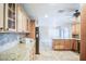 Well-lit kitchen featuring custom wood cabinets, granite countertops, and stainless steel appliances at 2329 W Keating Ave, Mesa, AZ 85202