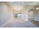 Open-concept living room featuring neutral carpet, arched doorways, and a chandelier, creating a warm and inviting space at 2329 W Keating Ave, Mesa, AZ 85202