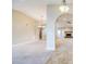 Spacious living room with neutral carpet, arched doorways, and abundant natural light, perfect for entertaining at 2329 W Keating Ave, Mesa, AZ 85202