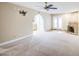 Spacious living room featuring a stone fireplace, carpet, and neutral paint at 2329 W Keating Ave, Mesa, AZ 85202