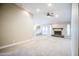 Cozy living room featuring neutral carpet, recessed lighting, a ceiling fan, and a fireplace for a relaxing atmosphere at 2329 W Keating Ave, Mesa, AZ 85202
