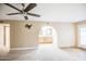 Expansive main bedroom with a ceiling fan, arched bathroom access, and a wall mount for a TV at 2329 W Keating Ave, Mesa, AZ 85202