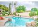 Sparkling pool with rock features offers a refreshing escape in the serene backyard, perfect for leisure and fun at 2329 W Keating Ave, Mesa, AZ 85202