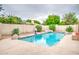 Backyard pool is surrounded by desert landscaping, creating a private oasis for recreation and relaxation at 2329 W Keating Ave, Mesa, AZ 85202