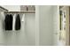 Well-organized closet with ample hanging space and shelves, offering plenty of storage solutions at 23398 W Sonrisas St, Buckeye, AZ 85326