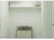 A laundry room featuring ample shelving for storage and a convenient laundry cart for sorting at 23398 W Sonrisas St, Buckeye, AZ 85326