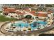 Community pool and clubhouse aerial featuring landscaped grounds, umbrellas, and palm trees at 26753 W Zachary Dr, Buckeye, AZ 85396