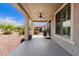 Covered back patio with ceiling fan overlooking gravel backyard landscaping at 26753 W Zachary Dr, Buckeye, AZ 85396