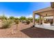Desert landscaping in backyard with covered patio view at 26753 W Zachary Dr, Buckeye, AZ 85396