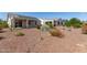 View of back of house with patio and backyard desert landscaping at 26753 W Zachary Dr, Buckeye, AZ 85396