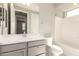 Bathroom with large mirror, vanity with gray cabinets and white countertop, and tub at 26753 W Zachary Dr, Buckeye, AZ 85396