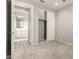 Bright bedroom with carpeted floor and view to sliding closet and bathroom at 26753 W Zachary Dr, Buckeye, AZ 85396