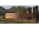 A well-maintained community entrance sign with desert landscaping and mountain backdrop at 26753 W Zachary Dr, Buckeye, AZ 85396
