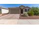 Charming single-story home featuring a brick driveway and a two-car garage at 26753 W Zachary Dr, Buckeye, AZ 85396