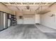 Spacious garage with storage cabinets, overhead racks and epoxy flooring at 26753 W Zachary Dr, Buckeye, AZ 85396