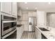 Modern kitchen featuring stainless appliances, white cabinets, and marble countertops at 26753 W Zachary Dr, Buckeye, AZ 85396
