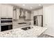 Modern kitchen with stainless steel appliances and a large marble island at 26753 W Zachary Dr, Buckeye, AZ 85396