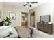 A well-lit bedroom with a ceiling fan, a dresser, and a doorway that goes into a bathroom at 2989 N 44Th N St # 2007, Phoenix, AZ 85018