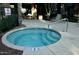 Inviting in-ground hot tub with tile trim, stainless steel handrail, and visible 'No Smoking' sign at 2989 N 44Th N St # 2007, Phoenix, AZ 85018