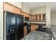 Traditional kitchen featuring granite counters, wood cabinets, and black appliances at 2989 N 44Th N St # 2007, Phoenix, AZ 85018