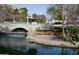 Scenic view of pond with waterfall feature, stone-lined banks, and bridge at 2989 N 44Th N St # 2007, Phoenix, AZ 85018