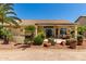 Well-maintained covered back patio with lush landscaping and desert foliage at 3166 N 158Th Ave, Goodyear, AZ 85395