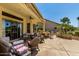 Charming covered patio with an array of wicker furniture to relax and enjoy the outdoors at 3166 N 158Th Ave, Goodyear, AZ 85395