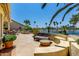 Relaxing back patio with seating area overlooking the lake and palm trees at 3166 N 158Th Ave, Goodyear, AZ 85395