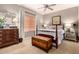 Bedroom with wooden furniture, wooden chest, ceiling fan and neutral decor at 3166 N 158Th Ave, Goodyear, AZ 85395