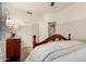 Bedroom with wooden furniture, ceiling fan, closet and adjoining bathroom access at 3166 N 158Th Ave, Goodyear, AZ 85395