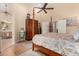 Bright bedroom with neutral decor, wood floors, ceiling fan and walk-in closet at 3166 N 158Th Ave, Goodyear, AZ 85395