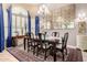 Elegant dining room featuring a large table, chandelier, and plenty of natural light for gatherings at 3166 N 158Th Ave, Goodyear, AZ 85395