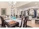 Spacious dining room with seating for six, chandelier, and open layout, perfect for entertaining guests at 3166 N 158Th Ave, Goodyear, AZ 85395