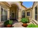 Inviting entryway with decorative columns and desert landscaping in decorative planters at 3166 N 158Th Ave, Goodyear, AZ 85395