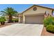 Charming home features a two-car garage and well-maintained desert landscaping, offering curb appeal at 3166 N 158Th Ave, Goodyear, AZ 85395