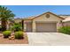 Charming home features a two-car garage and well-maintained desert landscaping, offering curb appeal at 3166 N 158Th Ave, Goodyear, AZ 85395