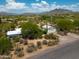 Beautiful aerial view of the property, showcasing the house, desert landscaping, and surrounding mountains at 33601 N Rifleman Rd, Cave Creek, AZ 85331