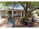 Backyard patio area features a bench with an open beam overhang, various potted plants and sculptures at 33601 N Rifleman Rd, Cave Creek, AZ 85331