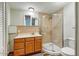 Bathroom features a wooden vanity, curved shower, and a white toilet for functionality and comfort at 33601 N Rifleman Rd, Cave Creek, AZ 85331