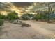 Large, low maintenance desert yard with mature trees and natural stone landscaping at 33601 N Rifleman Rd, Cave Creek, AZ 85331