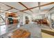 Spacious living room showcases exposed beam ceiling, an open floor plan, with views into the kitchen at 33601 N Rifleman Rd, Cave Creek, AZ 85331