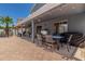Back patio with table and chairs, and well maintained landscaping at 3545 W Tanner Ranch Rd, San Tan Valley, AZ 85144
