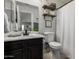 Well-lit bathroom with a single sink vanity and decorative shelving above the toilet at 3545 W Tanner Ranch Rd, San Tan Valley, AZ 85144