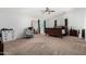 Large primary bedroom with a ceiling fan, plush carpet, and ample natural light at 3545 W Tanner Ranch Rd, San Tan Valley, AZ 85144